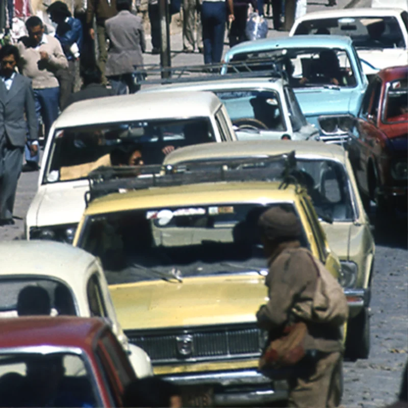 Tráfico vehicular y peatones en una calle concurrida de La Paz.